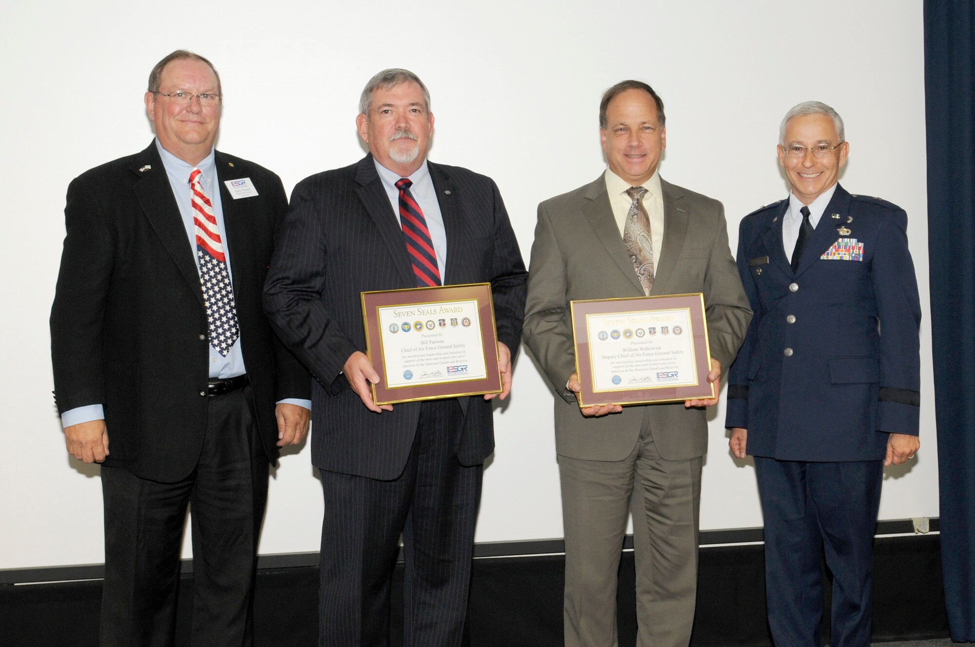 Bill "Top" Parsons,center left, Air Force chief of ground safety, and Bill Walkowiak, center right, Air Force deputy chief of ground safety, received Employer Support of the Guard and Reserve Patriot Awards for outstanding support of their employees who are members of the Air Force Reserve.The awards were presented Oct. 3 at the Air Force Safety Center, Kirtland Air Force Base, N.M. Making the presentations were Gary Kaiser, left, ESGR program support manager, and Brig. Gen. Andrew Salas, right, New Mexico adjutant general. (U.S. Air Force photo/Keith Wright)