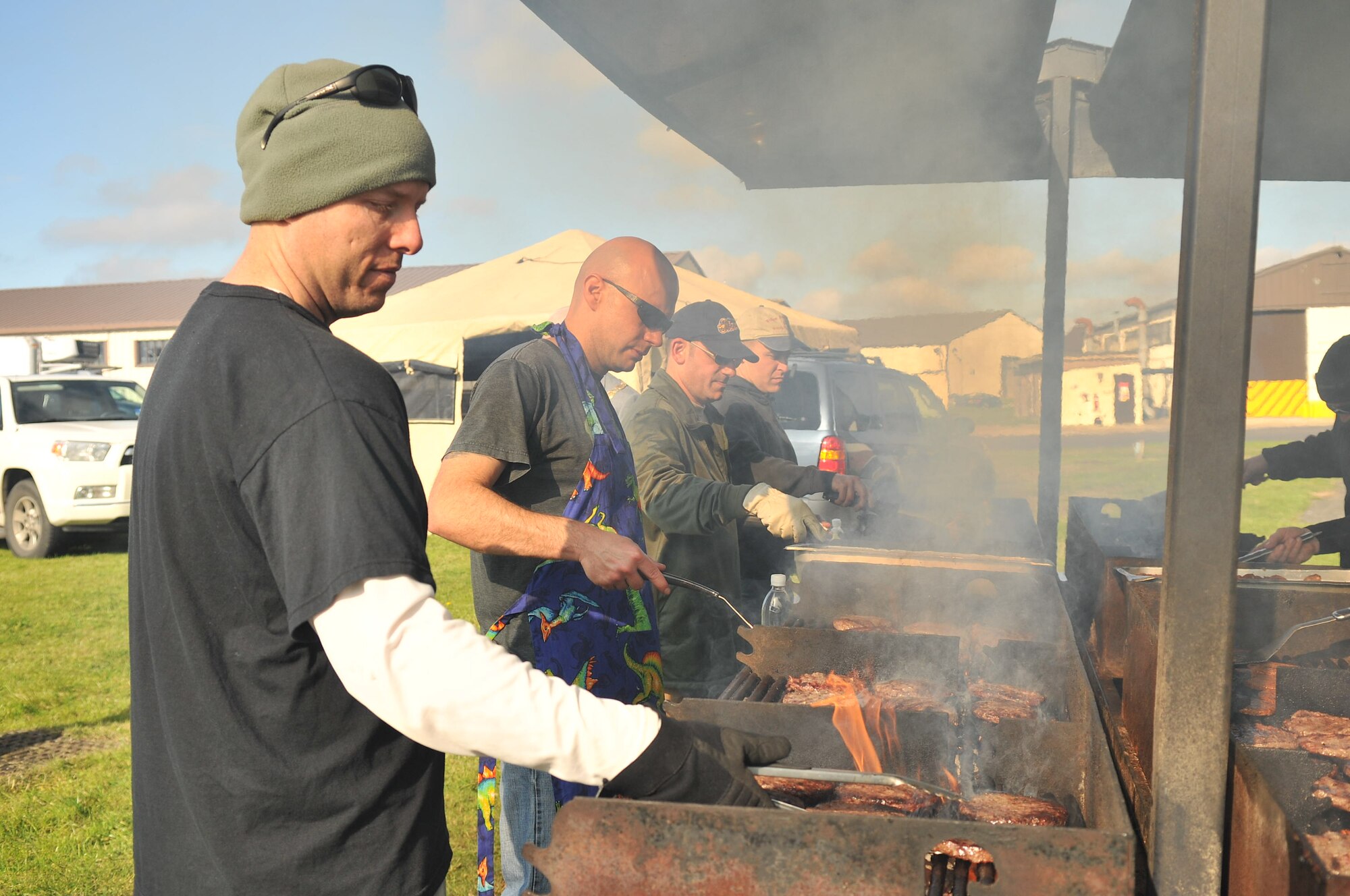 Members of Team Mildenhall First Sergeants’ Association grill burgers duringJoan Mann Special Sports Day Oct. 13, 2012, at RAF Mildenhall, England. More than 1,000 hotdogs and hamburgers were prepared for the event which hosted more than 200 special athletes from the local area. (U.S. Air Force photo by Senior Airman Jerilyn Quintanilla/Released)
