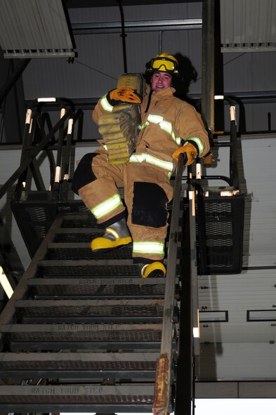 Capt. David Ratté, 100th Security Forces Squadron ‘SFS 1’ team, carries a hose pack down a set of stairs during a fire muster Oct. 11, 2012, at the 100th Civil Engineer Squadron Fire Department at RAF Mildenhall, England. The hose pack carry involved running up and down the stairs three times. Other events included Keiser sled, mannequin rescue and charged line advancement. (U.S. Air Force photo by Karen Abeyasekere/Released)