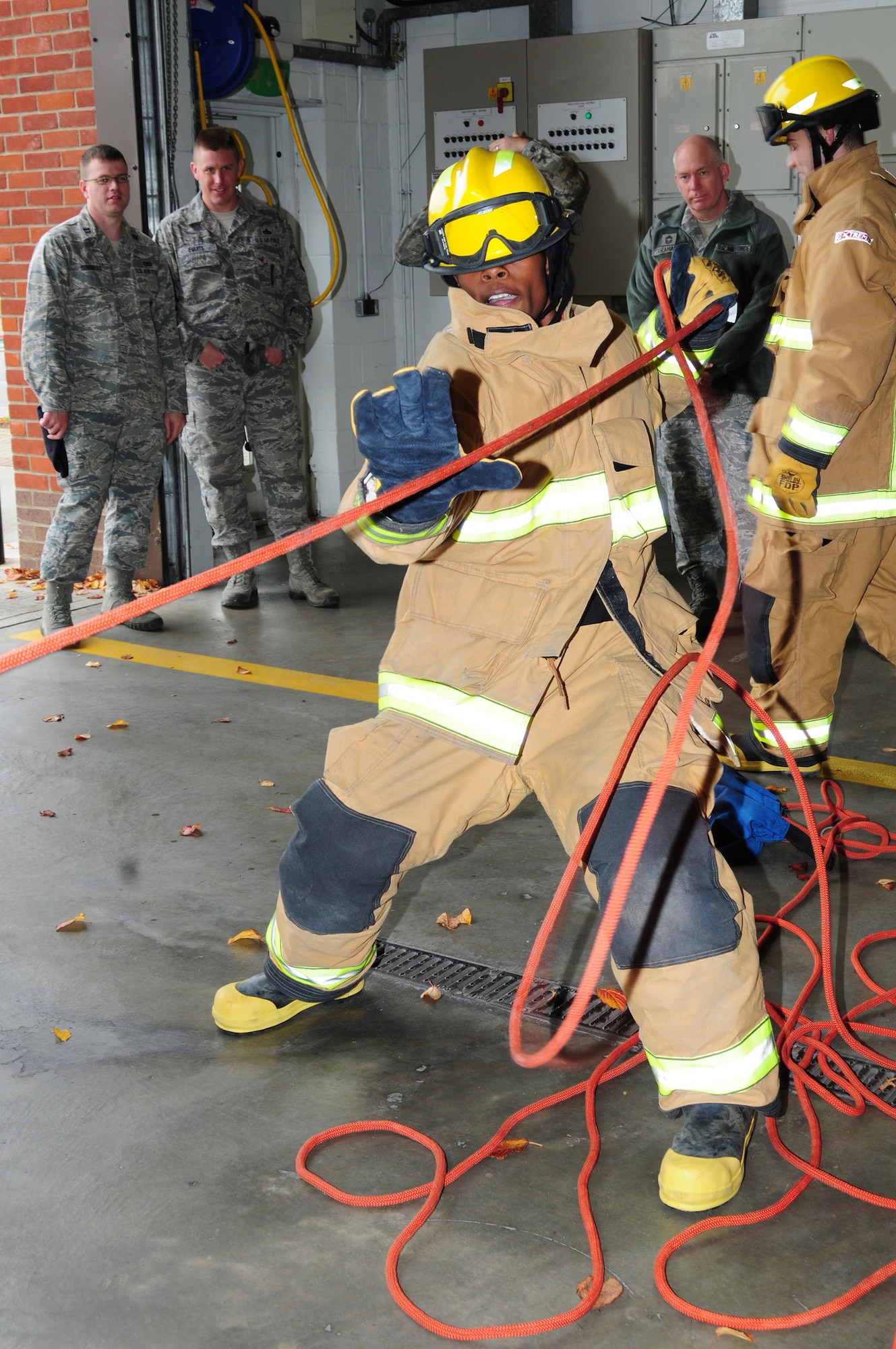 A participant pulls a rolled fire hose during one of the events at the fire muster Oct. 11, 2012, at the 100th Civil Engineer Squadron Fire Department, RAF Mildenhall, England. The 100th Security Forces Squadron ‘Raptor 56’ team won with a time of 9 minutes 37 seconds. (U.S. Air Force photo by Karen Abeyasekere/Released)