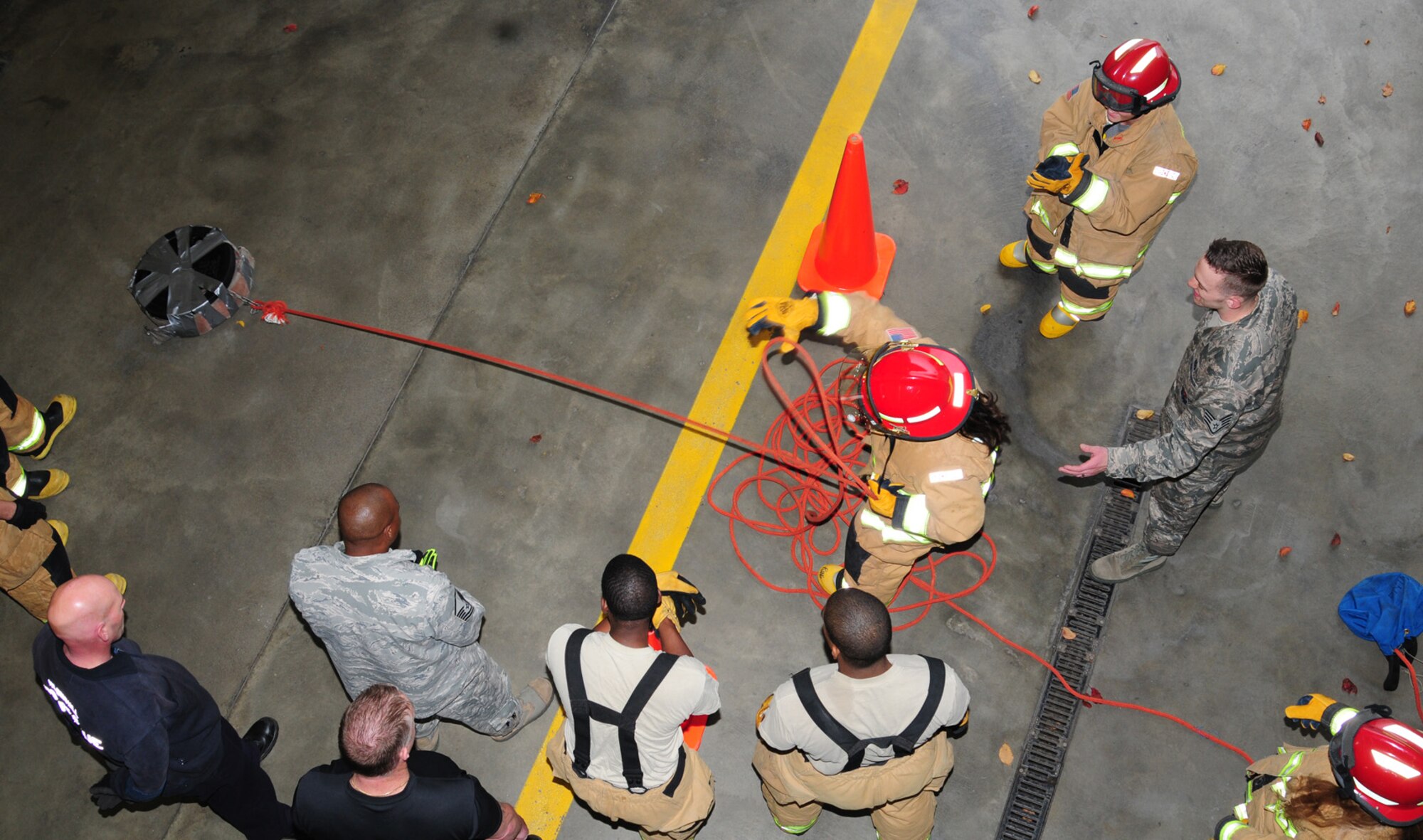 A competitor from the University of Maryland University College, also known as Team 2, ‘UMUC,’ drags a rolled hose during a fire muster Oct. 11, 2012, at the 100th Civil Engineer Squadron Fire Department at RAF Mildenhall, England. The fire muster was one of several events for Fire Prevention Week, which also included an open house at the fire department, and visits to local and base schools by firefighters. (U.S. Air Force photo by Karen Abeyasekere/Released)
 
