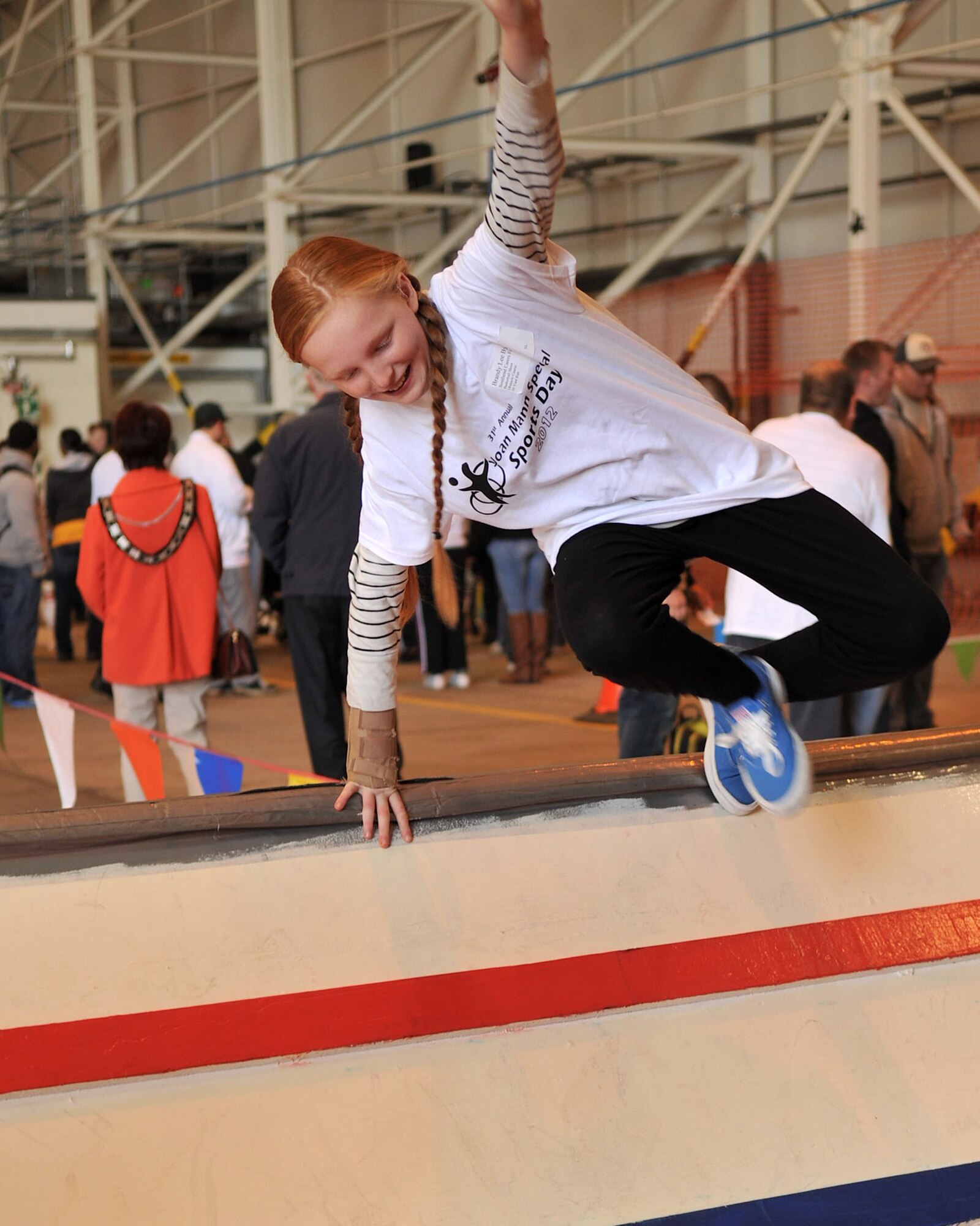 A participant of Joan Special Sports Day leaps over an obstacle course hurdle Oct. 13, 2012, at RAF Mildenhall, England. The event, which celebrated its 31st anniversary, began as a way to bring the military and local communities together. (U.S. Air Force photo by Senior Airman Jerilyn Quintanilla/Released) 