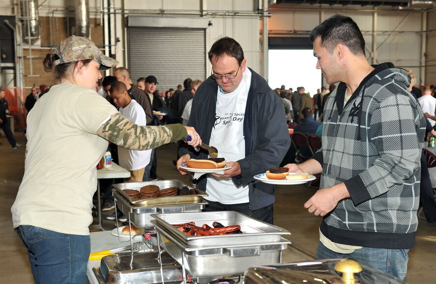 Brittany Cannon, 48th Operations Support Squadron Airfield Management, serves food during Joan Mann Special Sports Day Oct. 13, 2012, at RAF Mildenhall, England. More than 800 Airmen and their families from RAF Mildenhall, RAF Lakenheath, RAF Feltwell and RAF Alconbury volunteered to support the sports day, which is RAF Mildenhall's largest community relations event of the year. (U.S. Air Force photo by Senior Airman Jerilyn Quintanilla/Released)