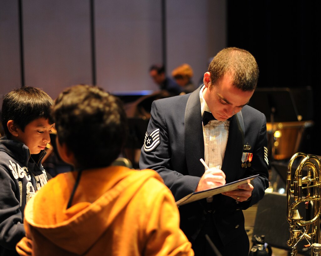 Tech. Sgt. David Rosengaft, U.S. Air Force Concert Band trombonist, signs autographs for youth after a concert in Pittsburg, Calif., Oct. 13. The concert is part of the U.S. Air Force Concert Band and Singing Sergeants 2012 Fall Tour. The band is scheduled to perform in 14 different cities on 14 nights.  (U.S. Air Force photo/ Staff Sgt. Keyonna Fennell)