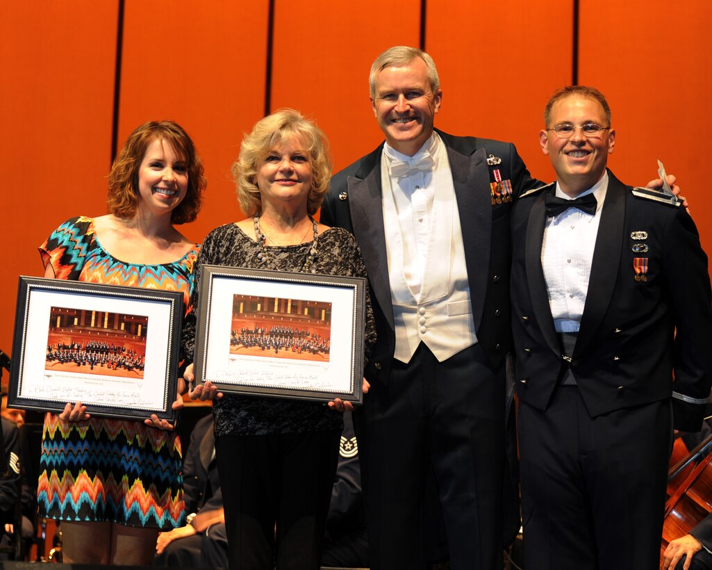 Col. Larry Lang, U.S. Air Force Band conductor and commander; and 1st Lt. Peter Folliard present the sponsors with a gift during the U.S. Air Force Concert Band and Singing Sergeants 2012 Fall Tour at Pittsburg High School in Pittsburg, Calif., Oct. 13. The Band is the Air Force’s premier musical organization which consists of six performing groups: the Air Force Strings, Ceremonial Brass, Concert Band, Max Impact, Singing Sergeants and Airmen of Note.  (U.S. Air Force photo/ Staff Sgt. Keyonna Fennell)