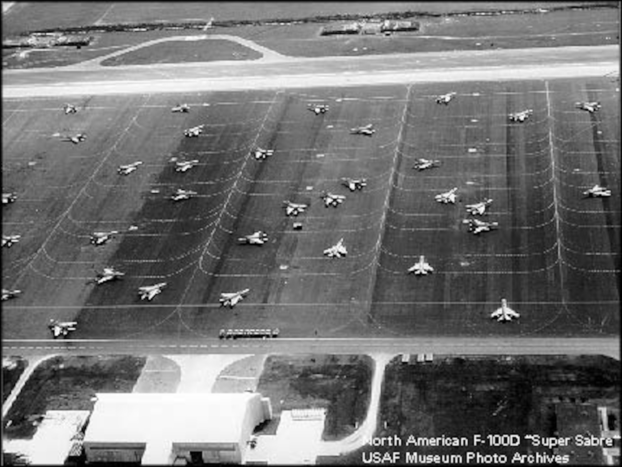 More than 30 F-100 Super Sabres sit on the flightline at Homestead Air Force Base, Fla., ready to respond at a moments notice during the Cuban Missile Crisis in 1962.  Aircraft were parked sporadically on the flightline to minimize damage in the event of an attack during the Cuban Missile Crisis.(courtesy photo)