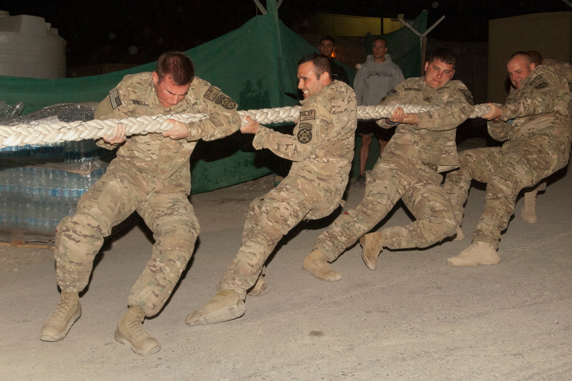 U.S. Army Soldiers participate in a tug-of-war contest at Bagram Airfield, Afghanistan, Oct. 13, 2012. The tug-of-war was a “two out of three” contest with two five-man teams competing. “Team America” came out on top by winning the first two matchups. The team included Airmen from the 455th Expeditionary Security Forces Squadron, Air Force Office of Special Investigations, and contractors. (U.S. Air Force photo/SSgt Jeff Nevison)