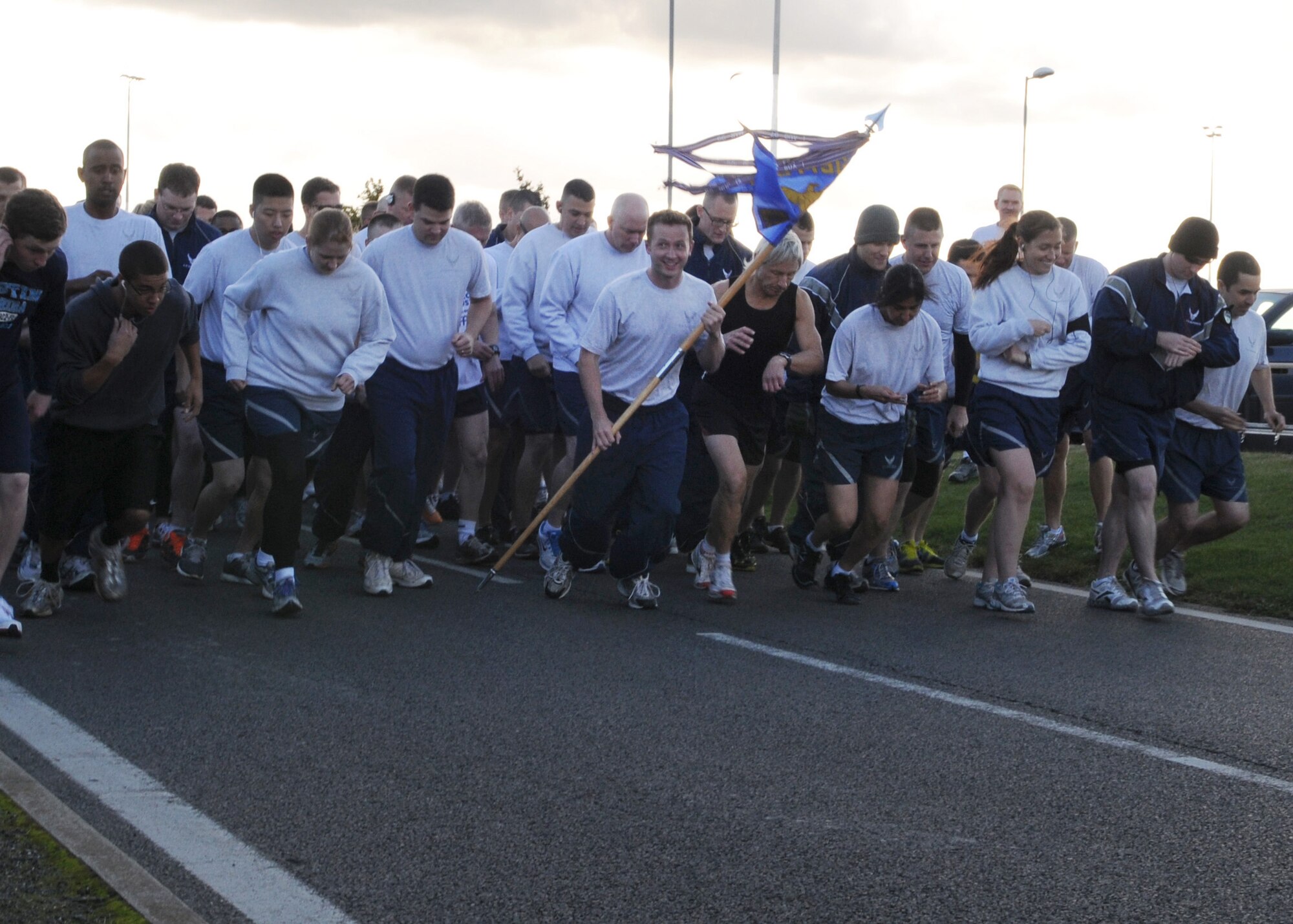 Members of Team Mildenhall take off from the starting line at the wing run Oct. 12, 2012, at RAF Mildenhall, England.  The monthly 5K run encourages morale and camaraderie throughout the base through exercise and healthy competition.  (U.S. Air Force photo by Staff Sgt. Tabitha Lee/Released)