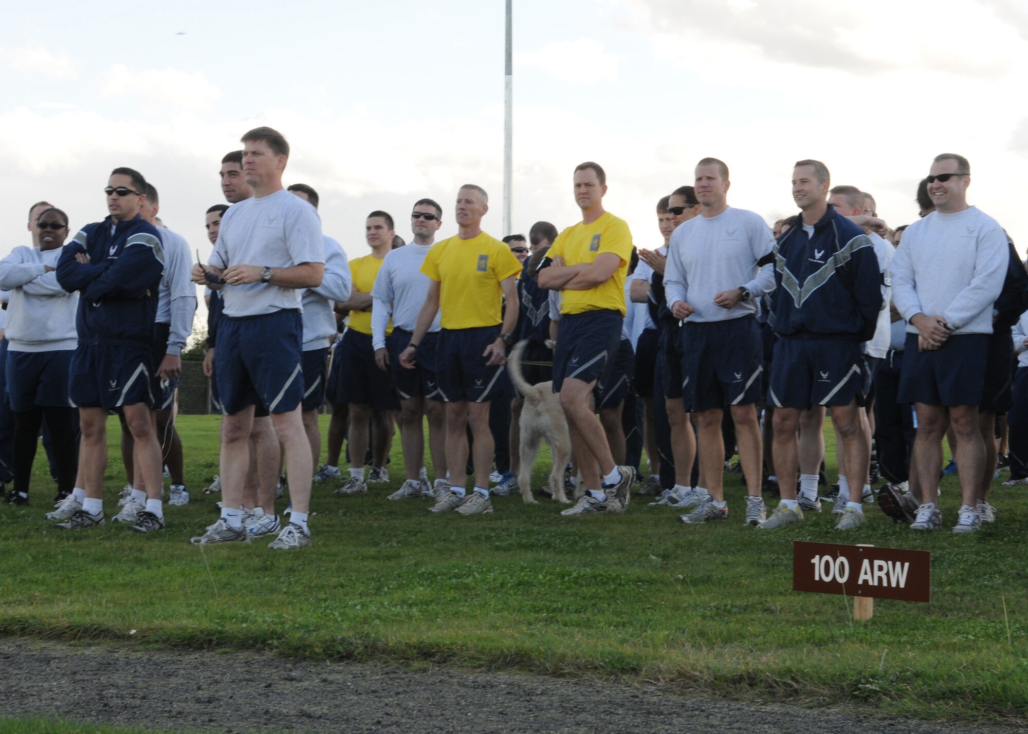 Members of Team Mildenhall listen to a briefing before the monthly wing 5K run Oct. 12, 2012, at RAF Mildenhall, England.  Before the run, Col. Christopher Kulas, 100th Air Refueling Wing commander, reminded base members to be conscious of fire safety as part of Fire Prevention Week.  (U.S. Air Force photo by Staff Sgt. Tabitha Lee/Released) 