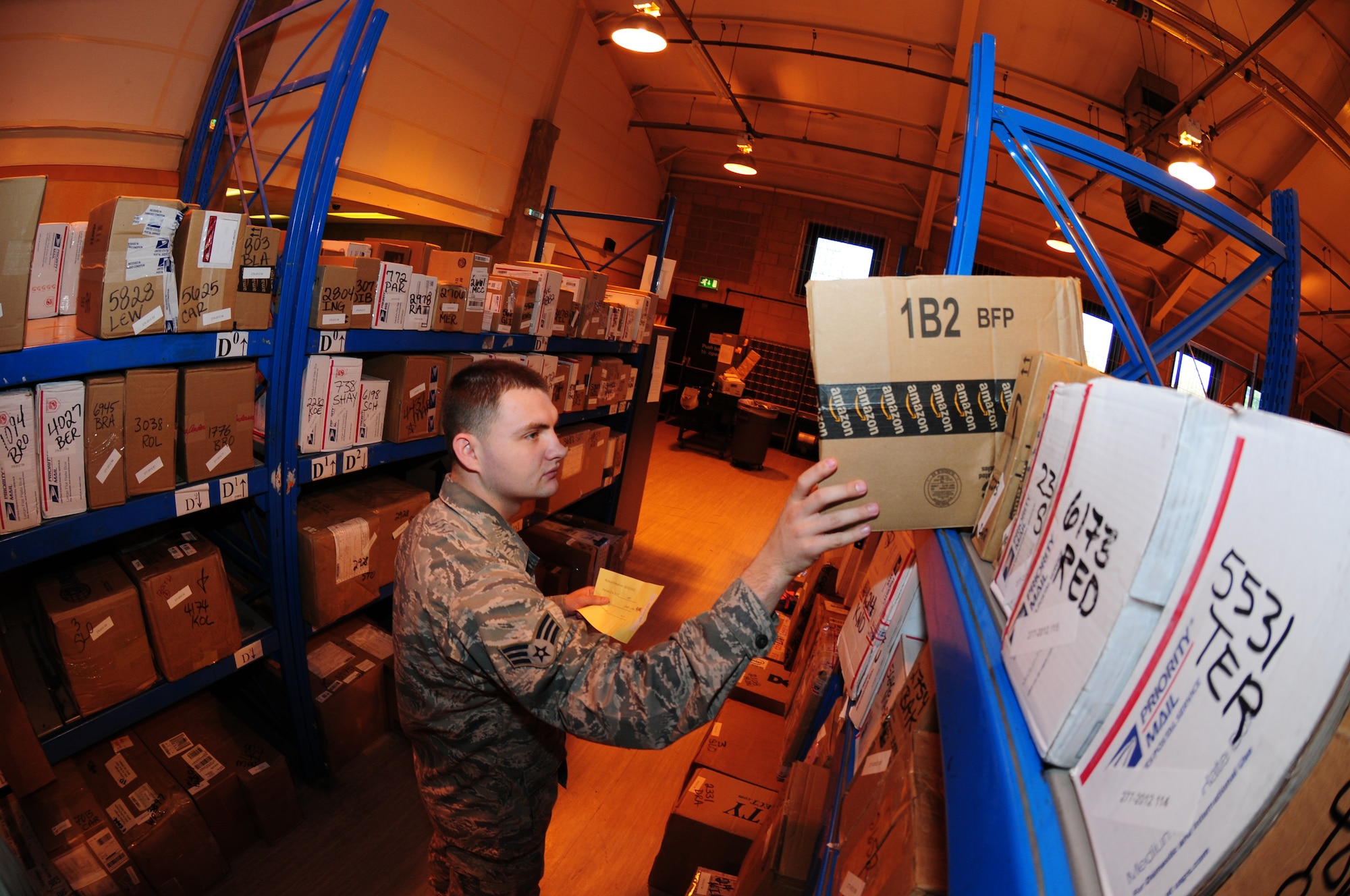 ROYAL AIR FORCE LAKENHEATH, England – Senior Airman William Courtois, 48th Communications Squadron postal clerk, pulls a package off a shelf for a customer Oct. 4, 2011. The RAF Lakenheath Post Office processes over 5000 packages each month, a number that typically doubles during the holiday season. (U.S. Air Force photo by Airman 1st Class Cory D. Payne)