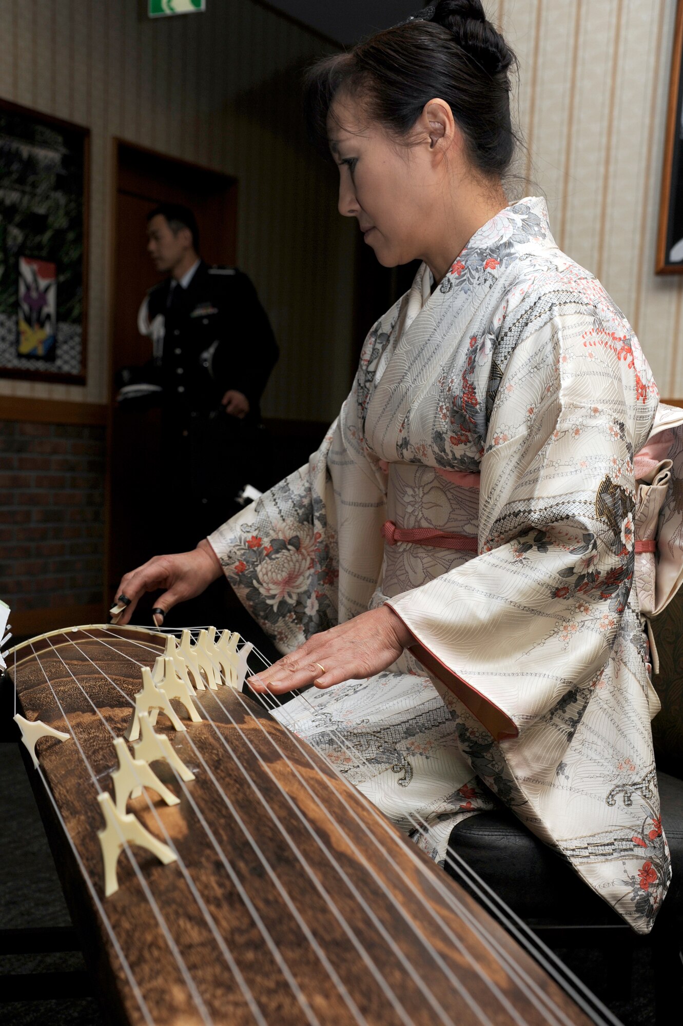 A member of the Koto Players entertains distinguished visitors prior to the start of the 65th Annual Air Force Ball celebration at Misawa Air Base, Japan, Oct. 13, 2012. This year's theme focused on Air Force history, a tradition of honor and legacy of valor. (U.S. Air Force photo by Tech. Sgt. Marie Brown)
