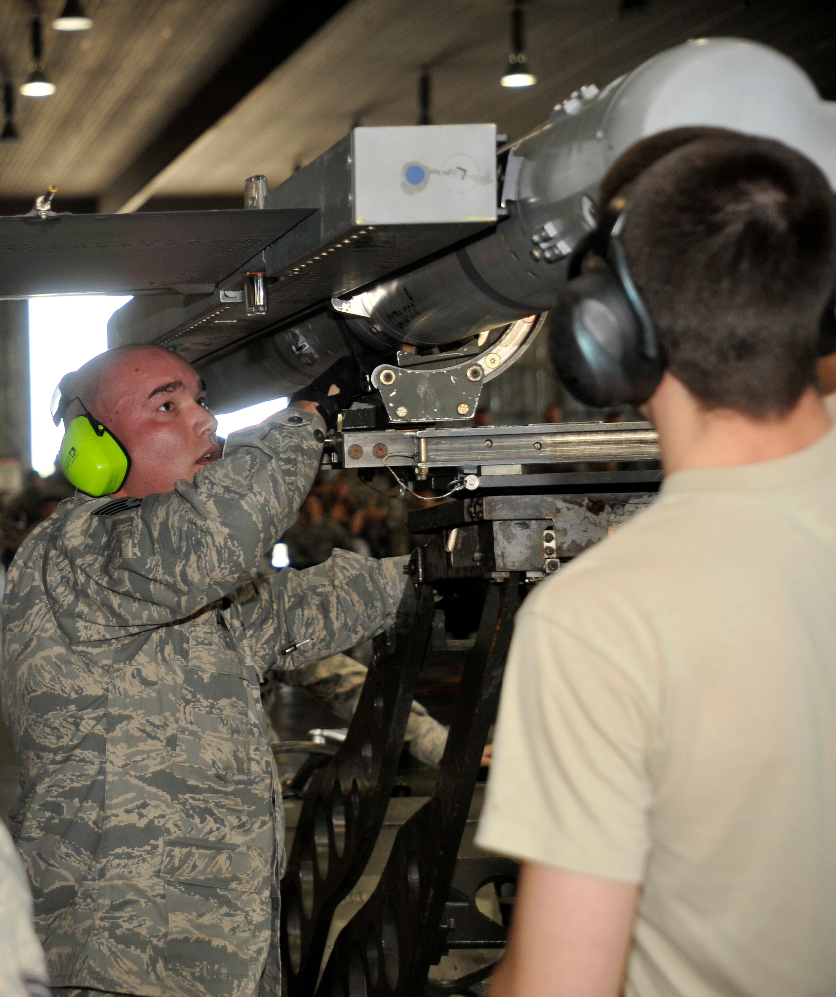 U.S. Air Force Staff Sgt. Corey Lindner, 14th Aircraft Maintenance Unit weapons load crew member, secures a AIM-120 Advanced Medium-Range Air-to-Air Missile during the load crew of the quarter competition at Misawa Air Base, Japan, Oct. 12, 2012. Along with competing for bragging rights, the 13 and 14 AMUs exhibited their primary combat skill and ability to provide safe, reliable and effective aircraft and munitions to support the Wild Weasel mission. (U.S. Air Force photo by Airman 1st Class Zachary Kee)