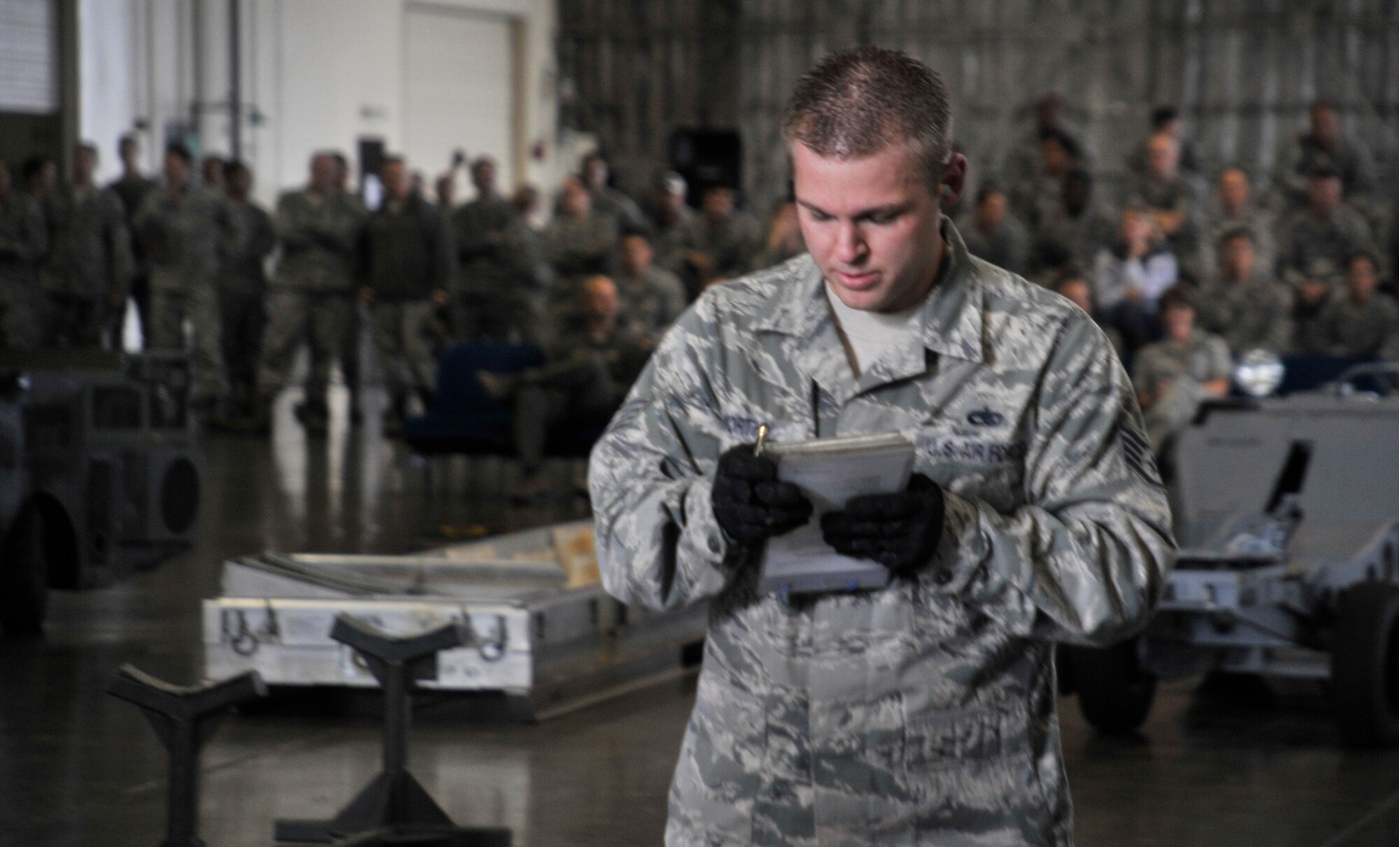 U.S. Air Force Staff Sgt. Ryan Worthy, 13th Aircraft Maintenance Unit weapons load crew member, looks over his team’s checklist as the crowd looks on at Misawa Air Base, Japan, Oct. 12, 2012. The 13 and 14 AMUs competed to see who had the best weapons load crew team in the 35th Aircraft Maintenance Squadron for the quarter. (U.S. Air Force photo by Airman 1st Class Zachary Kee)