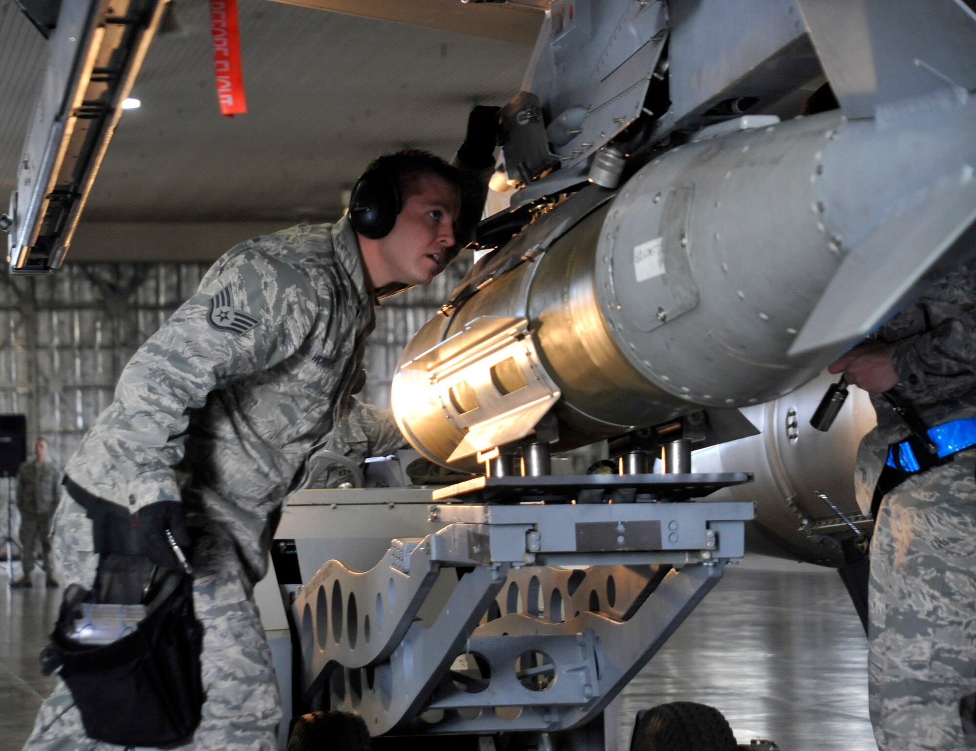 U.S. Air Force Staff Sgt. Ryan Worthy, 13th Aircraft Maintenance Unit weapons load crew member, looks over his team’s aircraft for any discrepancies after finishing their load during the weapons load crew of the quarter competition at Misawa Air Base, Japan, Oct. 12, 2012. Weapons Standardization evaluators chose the winning team by compiling a total score from inspections, a weapons subject matter test, their load time and the number of discrepancies found during the load. (U.S. Air Force photo by Airman 1st Class Zachary Kee)