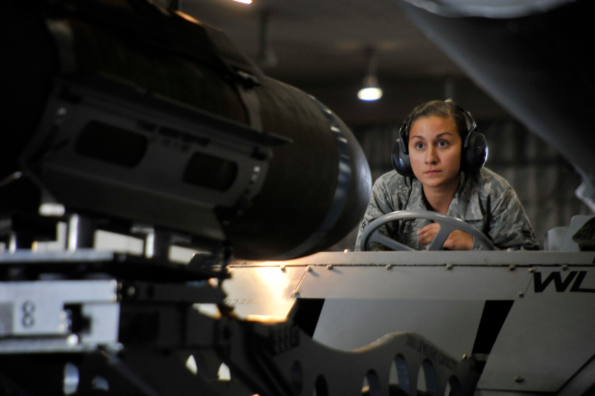 U.S. Air Force Airman 1st Class Danielle Falletta, 13th Aircraft Maintenance Unit weapons load crew member, looks on from an MJ-1 lift truck as her team competes for load crew of the quarter at Misawa Air Base, Japan, Oct. 12, 2012. As the best weapons load crew of the quarter, Falletta and her team won the competition with 1,260 points and finished with a load time of 21:10. (U.S. Air Force photo by Airman 1st Class Zachary Kee)