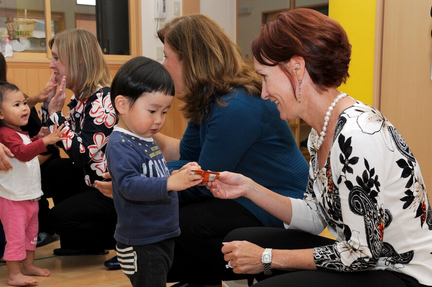 Marci Angelella, wife of Lt. Gen. Sam Angelella, U.S. Force Japan, 5th Air Force commander, hands candy to a child at the Sabishiro Child Care Center in Misawa City, Japan, Oct. 11, 2012. The center was affected by the earthquake and tsunami that hit northern Japan last year. (U.S. Air Force photo by Tech. Sgt. Marie Brown)