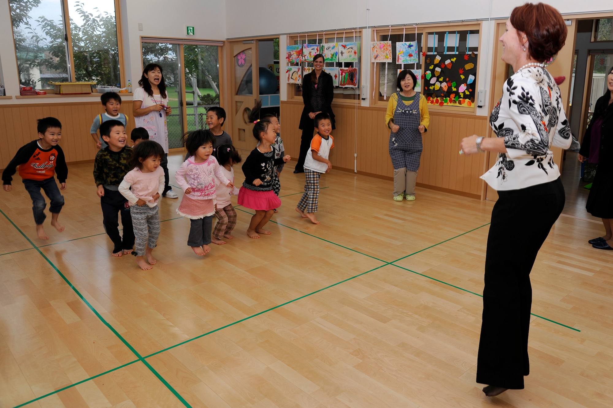 Marci Angelella, wife of Lt. Gen. Sam Angelella, U.S. Force Japan, 5th Air Force commander, plays a game with children of the Sabishiro Child Care Center in Misawa City, Japan, Oct. 11, 2012. Angelella and 35th Fighter Wing leadership spouses played games and spent time with the 25 children who go to day care there. (U.S. Air Force photo by Tech. Sgt. Marie Brown)