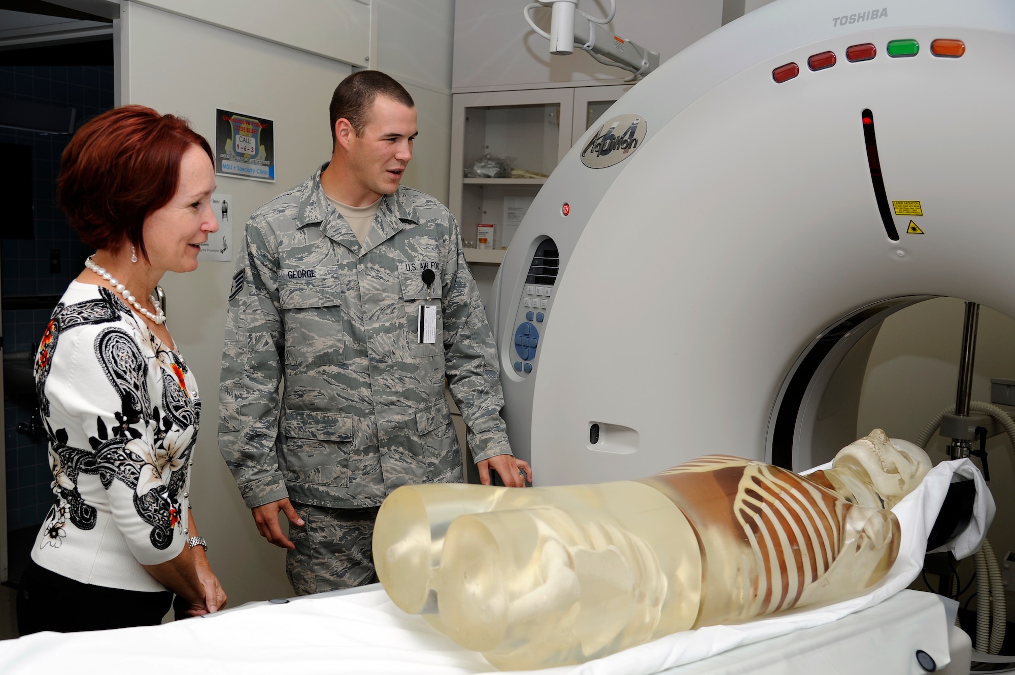 U.S. Air Force Staff Sgt. Michael George, right, 35th Surgical Operations Squadron diagnostic imaging and computed tomography technician, briefs Marci Angelella, wife of Lt. Gen. Sam Angelella, U.S. Force Japan, 5th Air Force commander, on a new CT scanner during her recent visit to the 35th Medical Group hospital at Misawa Air Base, Japan, Oct. 11, 2012. The 35 MDG received the new scanner in 2011 and has increased patient diagnostics by keeping patients on base rather than transporting them to Japanese medical care facilities. (U.S. Air Force photo by Tech. Sgt. Marie Brown)