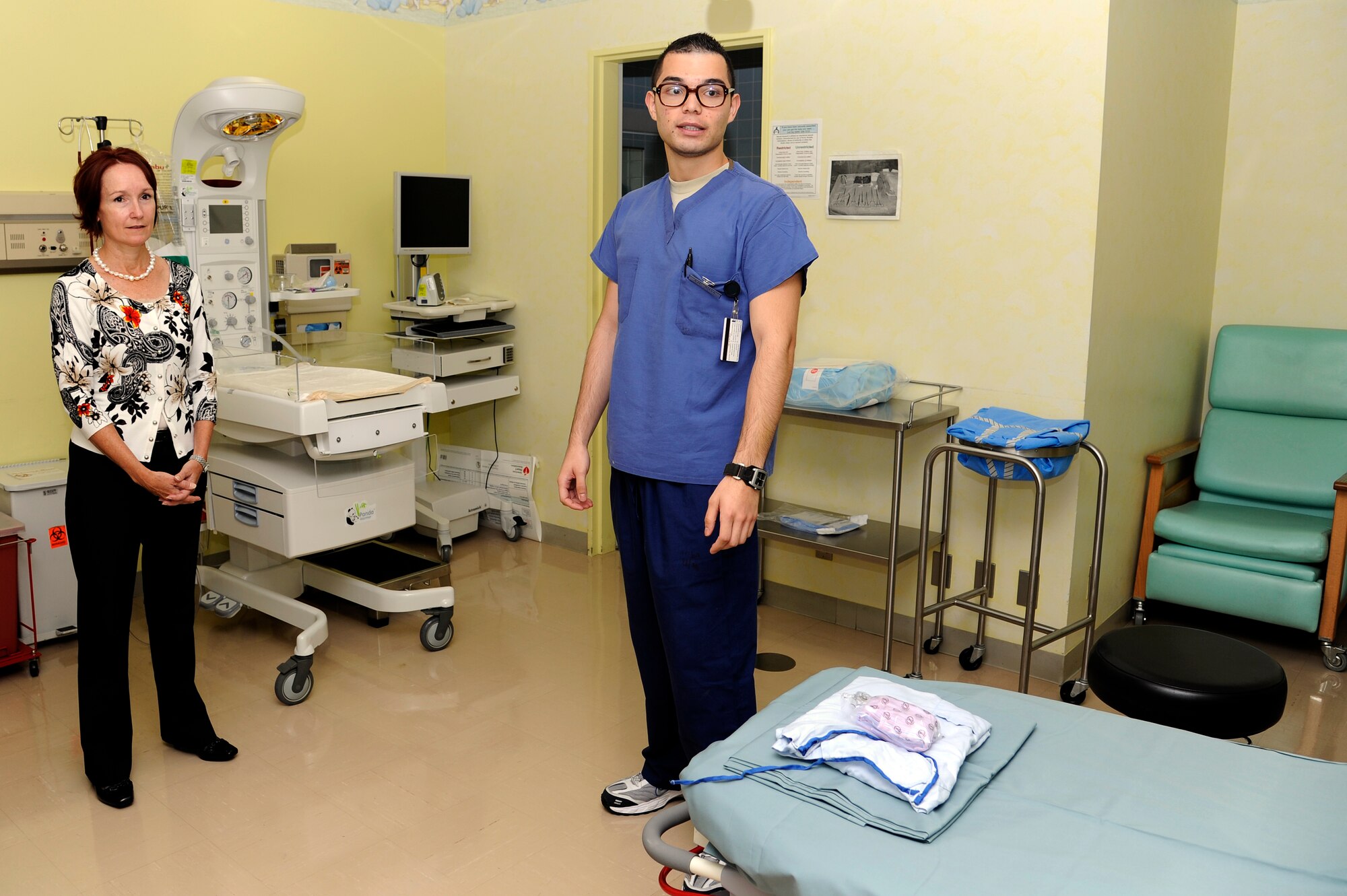 U.S. Air Force Airman 1st Class Christian Silva, 35th Surgical Operations Squadron medical technician, briefs Marci Angelella, wife of Lt. Gen. Sam Angelella, U.S. Force Japan, 5th Air Force commander, about operations in the maternal newborn unit at the base hospital, Misawa Air Base, Japan, Oct. 11, 2012. During her visit, Angelella talked with Airmen and toured newly upgraded base facilities. (U.S. Air Force photo by Tech. Sgt. Marie Brown)