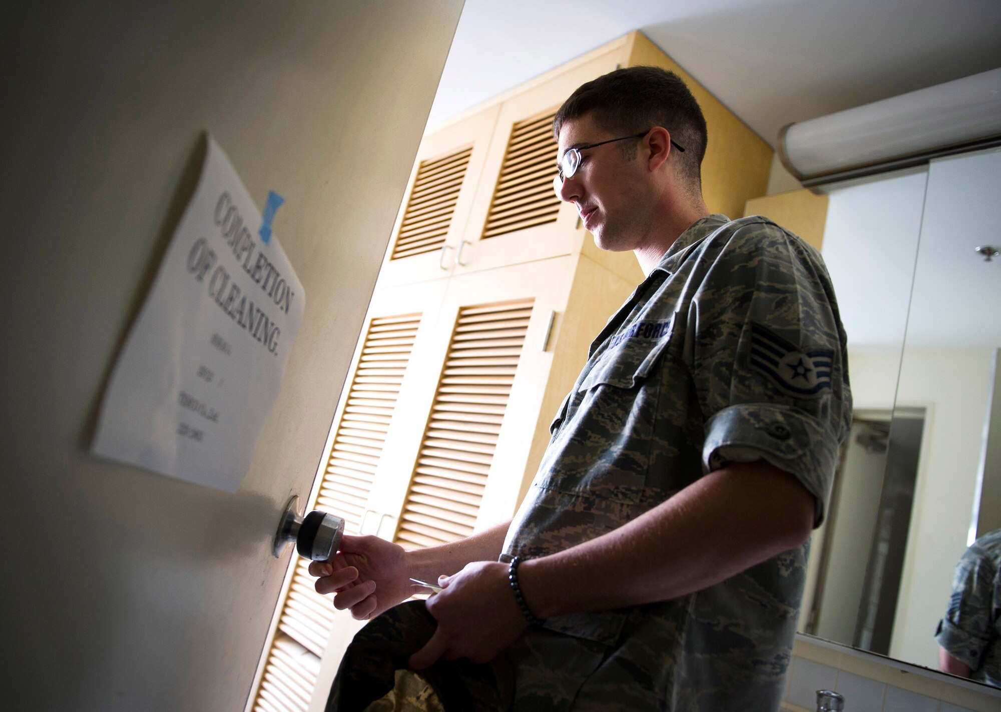 YOKOTA AIR BASE, Japan -- Staff Sgt. Michael Redl, 374th Civil Engineer Squadron Airman dorm leader, checks to ensure a room key is working properly at Yokota Air Base, Japan, on Oct. 11, 2012. Redl is one of five ADLs in charge of more than one thousand Airmen in 10 dormitories (U.S. Air Force photo by Staff Sgt. Chad C. Strohmeyer)