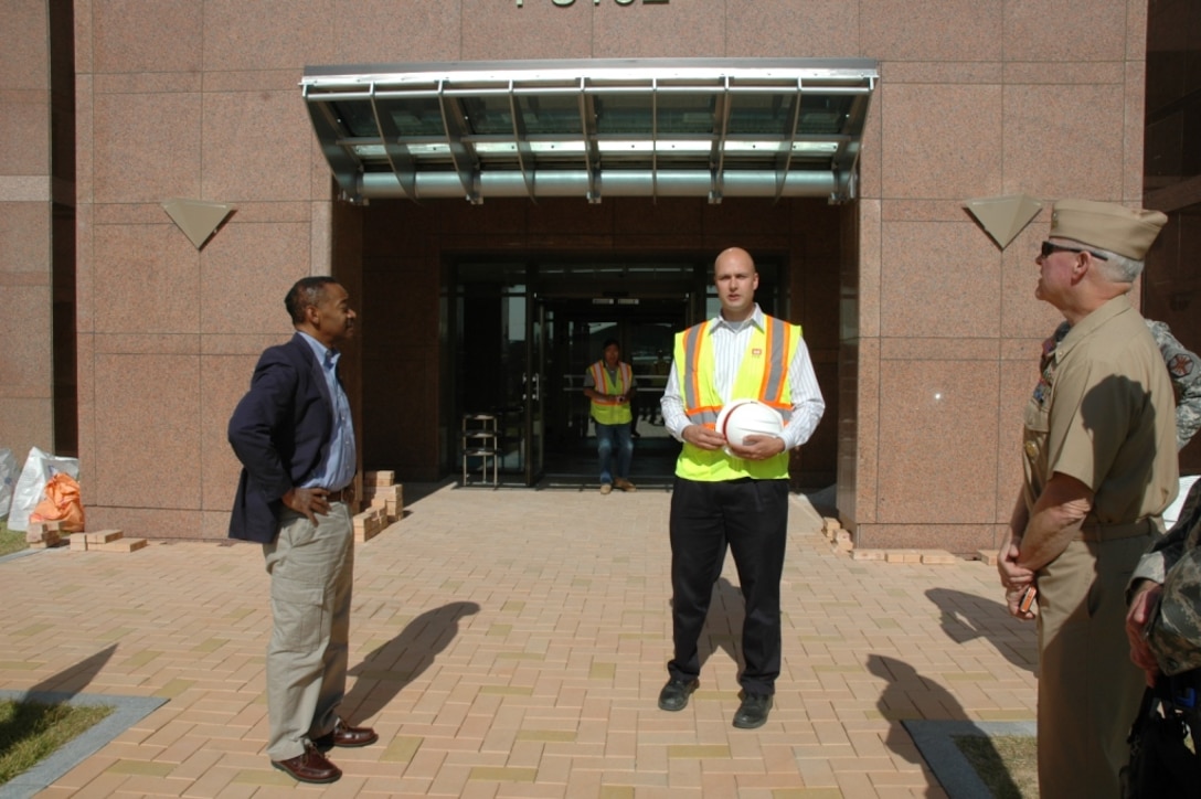 David Talbot, Far East District Family Housing Resident Office engineer, at right, briefs Dr. Jonathan Woodson, assistant secretary of
defense for health affairs and director, TRICARE Management Activity during a visit to U.S. Army Garrison Humphreys Oct. 15.
