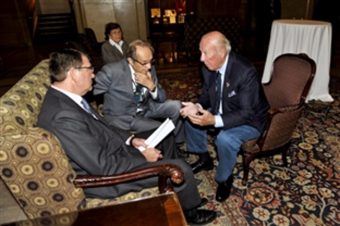 U.S. Deputy Defense Secretary Ashton B. Carter, left, former U.S. Defense Secretary William J. Perry, center, and former U.S. Secretary of State George P. Shultz, right, visit together following Carter's speech at the North American Forum conference in Ottawa, Ontario, Oct. 13, 2012. 