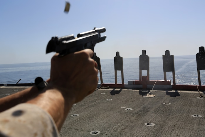 USS GUNSTON HALL, Gulf of Oman (Oct. 5, 2012) - A Marine with Combat Logistics Battalion 24, 24th Marine Expeditionary Unit, fires an M-9 Beretta pistol during sustainment training on the flight deck of the USS Gunston Hall in the Gulf of Oman, Oct. 5, 2012. The 24th MEU is deployed with the Iwo Jima Amphibious Ready Group as a theater reserve and crisis response force for U.S. Central Command in the U.S. Navy's 5th Fleet area of responsibility. 