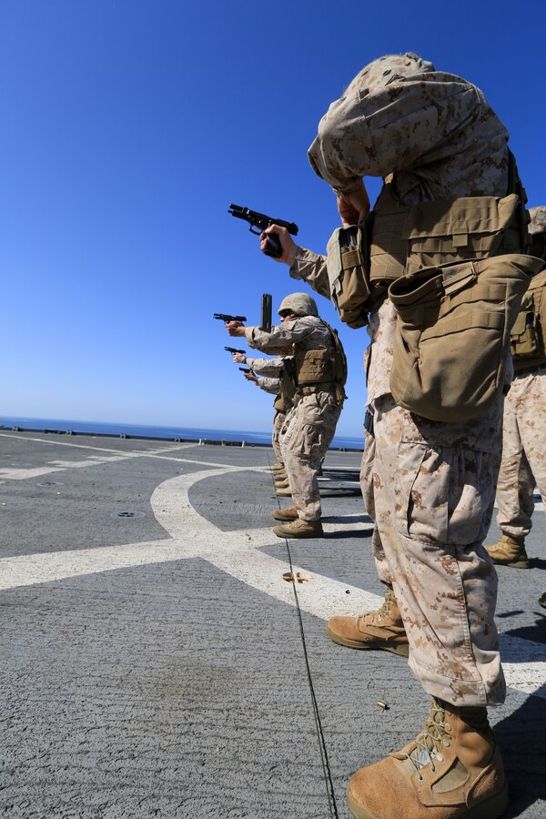 USS GUNSTON HALL, Gulf of Oman (Oct. 5, 2012) - Marines with Combat Logistics Battalion 24, 24th Marine Expeditionary Unit, conduct a live-fire speed reload drill with M-9 Beretta pistols during sustainment training on the flight deck of the USS Gunston Hall in the Gulf of Oman, Oct 5, 2012. The 24th MEU is deployed with the Iwo Jima Amphibious Ready Group as a theater reserve and crisis response force for U.S. Central Command in the U.S. Navy's 5th Fleet area of responsibility. 