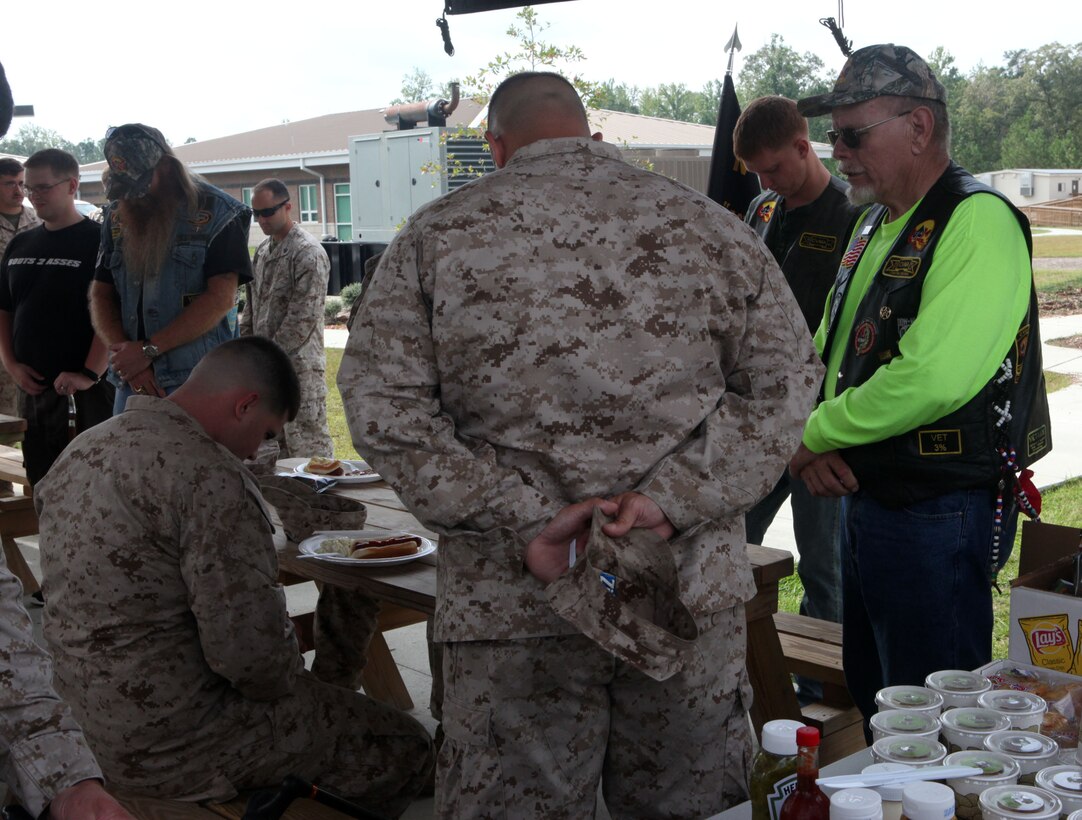 Arthur Barnes, member of North Carolina Combat Veteran Motorcycle Association, leads everyone in prayer before feasting at the barbecue held at Wounded Warriors Battalion Barracks aboard Marine Corps Base Camp Lejeune Oct. 4.  Barnes says he’s been with NCCVMA for four years and normally leads the prayer for meetings and events.