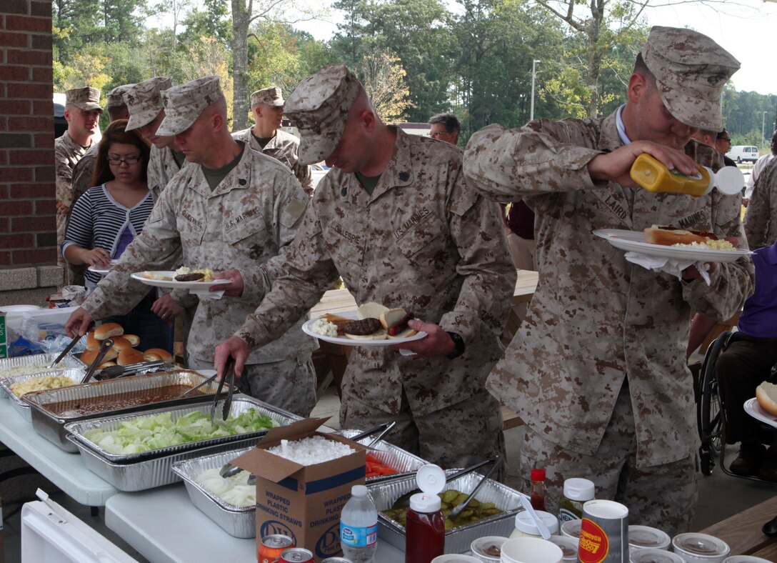 Marines with the Wounded Warrior Battalion-East fix plates of food at the barbecue held at the Wounded Warrior Battalion Barracks aboard Marine Corps Base Camp Lejeune Oct. 4.  The Marines in attendance expressed their appreciation and said the food was amazing.