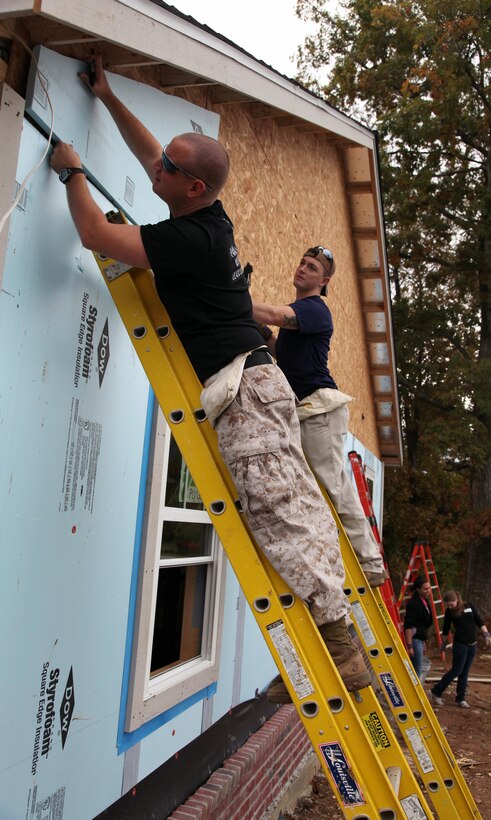 Sgt. Tommy D. Dunn, supply clerk, and Cpl. Roy D. Horsely, administrative clerk, install insulation during a volunteer effort from RS Nashville for Habitat for Humanity in Antioch, TN.