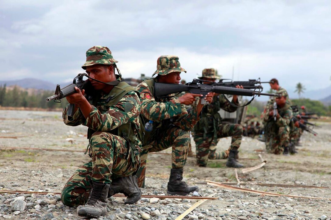 Soldiers with the Timor-Leste Defense Force practice their infantry tactics the evening before the conduct of a raid with India Company, Battalion Landing Team 3/5, 15th Marine Expeditionary Unit, as part of Exercise Crocodilo 2012, Oct. 12. Crocodilo12 serves as the first exercise scheduled during the MEU's deployment that began on Sept. 17. Throughout the exercise, forces will participate in various events to include field exercises and community relations activities aimed at strengthening the relationship between the US and Timor-Leste. The 15th MEU is currently embarked as part of the Peleliu Amphibious Ready Group, while they serve as the nation's rapid-response sea-based Marine Air Ground Task Force for Western Pacific Deployment 12-02.