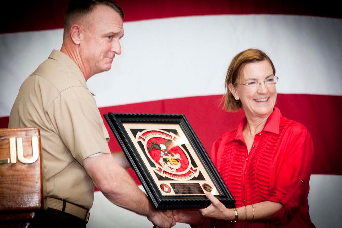 Colonel Scott D. Campbell, commanding officer, 15th Marine Expeditionary Unit, presents U.S. Ambassador to the country, Honorable Judith Fergin with a gift on behalf of the Marines of the 15th MEU during a distinguished visitor reception aboard the USS Peleliu, as part of Exercise Crocodilo 2012, Oct. 13. Throughout the exercise, the MEU participated in various events to include field exercises with the Timor-Leste Defense Force and community relations activities aimed at strengthening the relationship between the US and Timor-Leste.