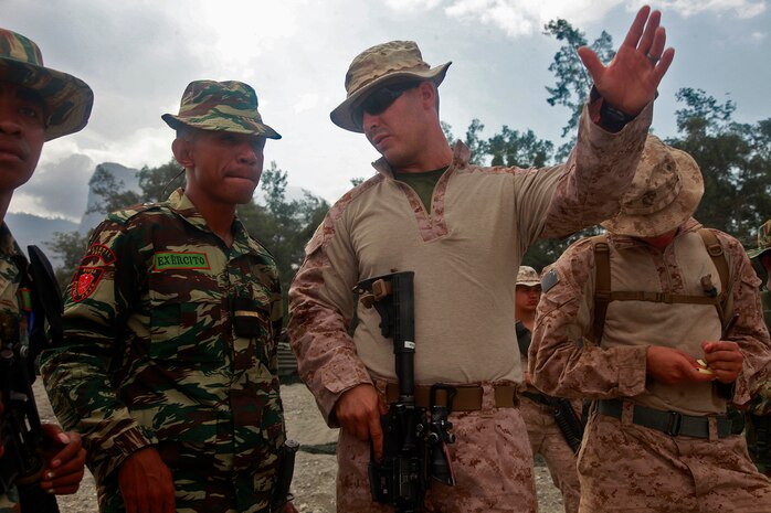 Corporal Joel L. Ortega, squad leader, 3rd Squad, 2nd Platoon, India Company, Battalion Landing Team 3/5, 15th Marine Expeditionary Unit, gives a class on patrolling to soldiers with the Timor-Leste Defense Force, as part of Exercise Crocodilo 2012, Oct. 13. Crocodilo12 serves as the first exercise scheduled during the MEU's deployment that began on Sept. 17. Throughout the exercise, forces will participate in various events to include field exercises and community relations activities aimed at strengthening the relationship between the US and Timor-Leste. The 15th MEU is currently embarked as part of the Peleliu Amphibious Ready Group, while they serve as the nation's rapid-response sea-based Marine Air Ground Task Force for Western Pacific Deployment 12-02. Ortega, 27, is from Miami.




