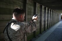 Lt Col. Nicholas A. Morris, Marine Heavy Helicopter Squadron 461 commanding officer, takes a well aimed shot during his pistol qualification at the range on Marine Corps Base Camp Lejeune, Sept. 27. HMH-461 undergoes training for deployment early next year.