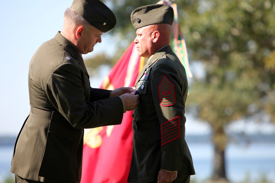 Camp Lejeune, N.C. Lt. Col. John Kelley pins a third Meritorious Service Medal on the chest of Master Gunnery Sgt. Richard Herald during his retirement ceremony at Paradise Point Officers’ Club aboard Marine Corps Base Camp Lejeune, N.C., Oct. 12, 2012.  Herald retired after 26 faithful years of service to the Marine Corps. (Official Marine Corps photo by Lance Cpl. Caleb McDonald/Released)