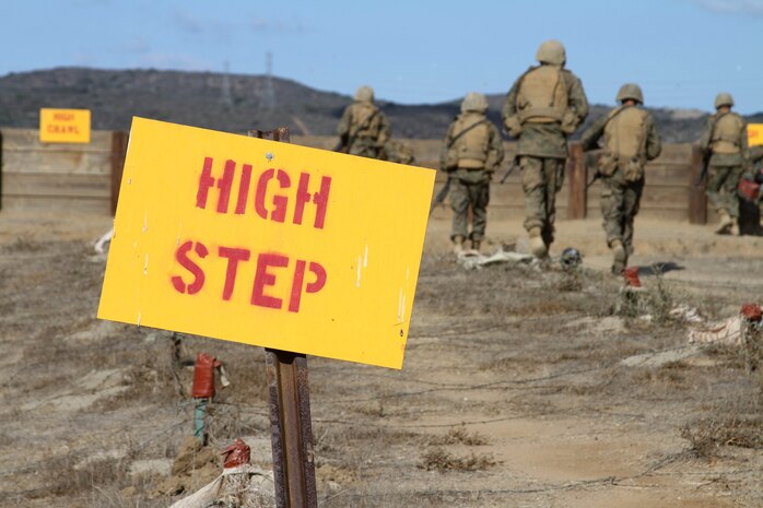 Recruits of Company A, 1st Recruit Training Battalion, move in teams of four through Howard's Assault course Oct. 11 aboard Marine Corps Base Camp Pendleton, Calif. Recruits move through obstacles which include walls, trenches, barb wire and tunnels while transporting an ammunition can. 