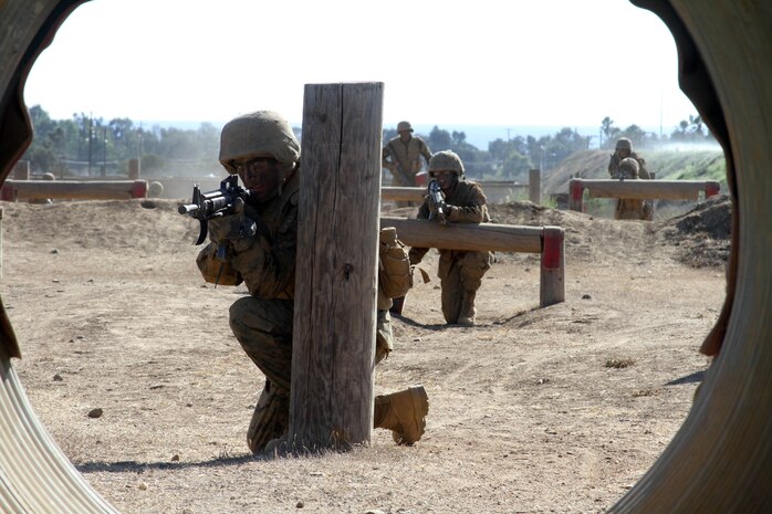 A recruit of Company A, 1st Recruit Training Battalion, posts security as the rest of his fire team moves through Howard's Assault course Oct. 11 aboard Marine Corps Base Camp Pendleton, Calif. The course simulaltes movement as a fire team and allows recruits to pratice communication skills. 