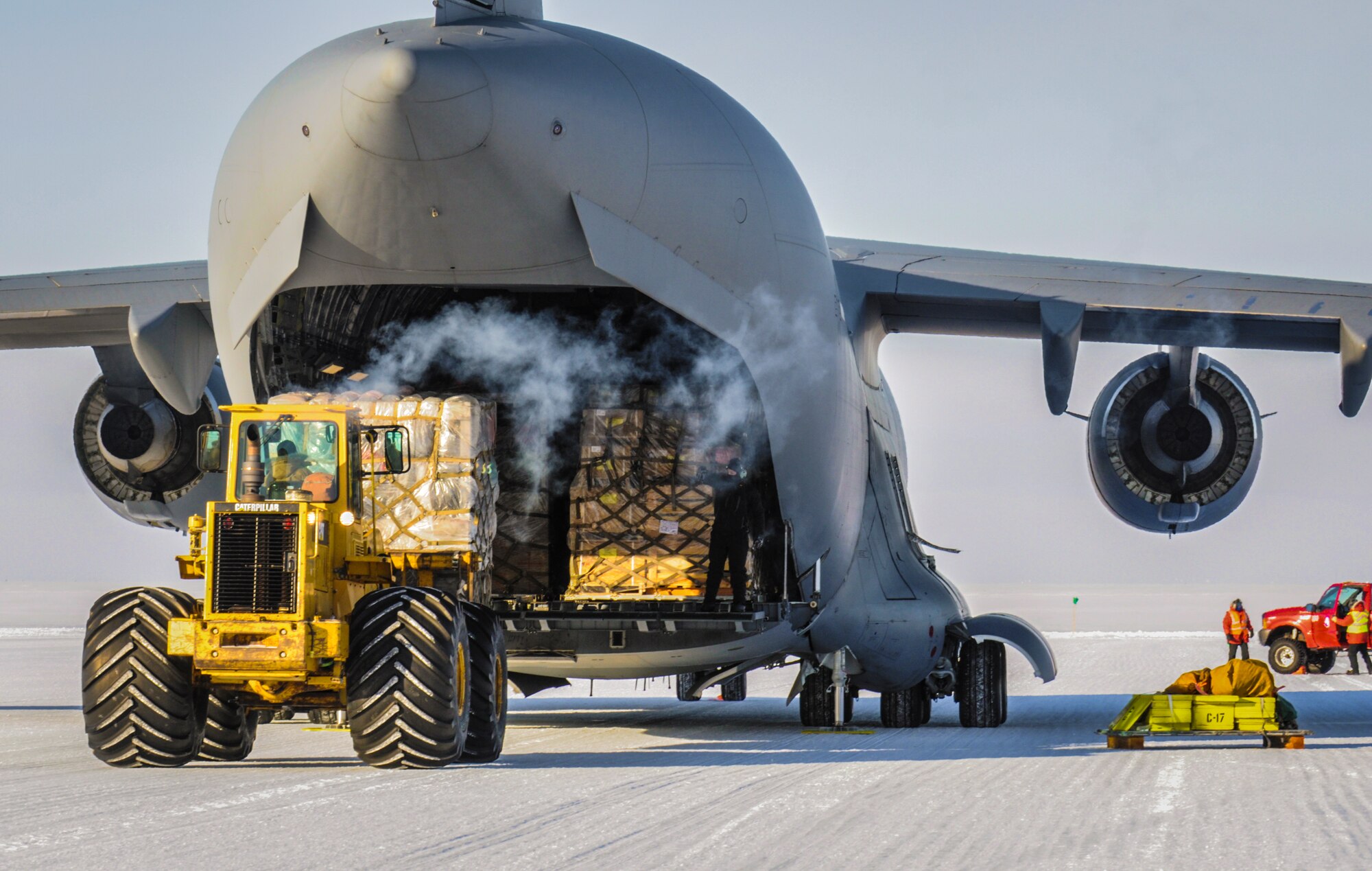 A C-17 Globemaster III aircraft from Joint Base Lewis-McChord, Wash., is off-loaded by a forklift, Oct. 1, 2012, at McMurdo Station, Antarctica. The plane delivered 64,000 pounds of cargo and 76 passengers to the research station in its first Operation Deep Freeze mission of the 2012-2013 main season. (U.S. Air Force photo/Staff Sgt. Sean Tobin)