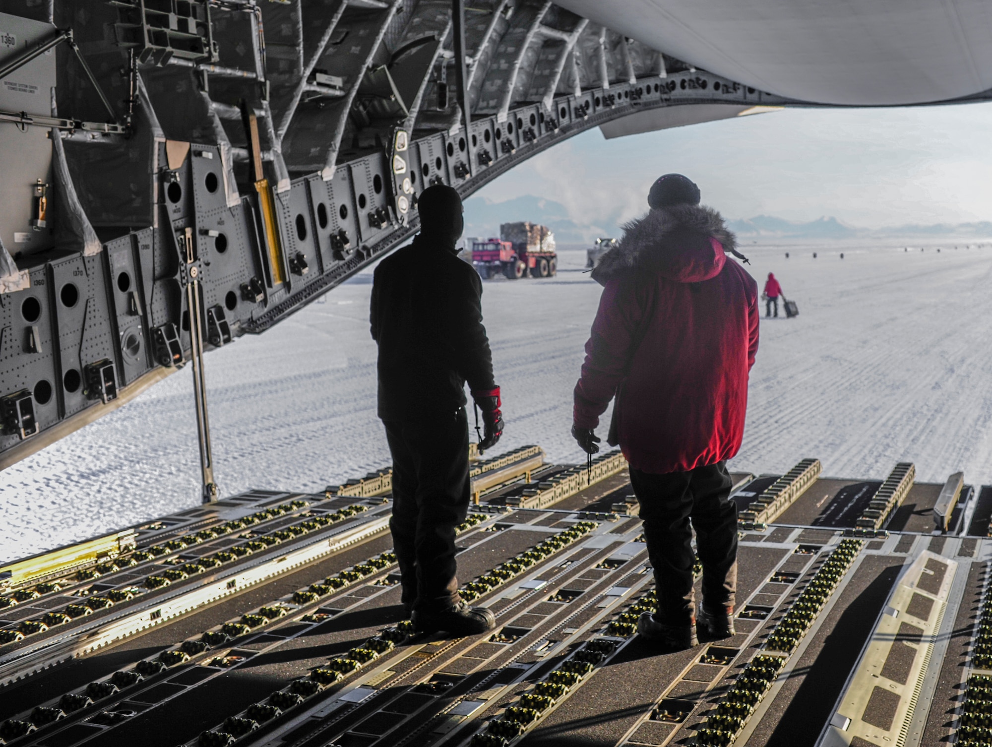 304th Expeditionary Airlift Squadron loadmasters wearing cold weather gear, await a forklift to load a pallet of cargo onto a C-17 Globemaster III aircraft, Oct. 1, 2012, on the seasonal ice runway outside of McMurdo Station, Antarctica. The temperature reached minus 35 degrees Fahrenheit while crews loaded and unloaded cargo in support of Operation Deep Freeze. (U.S. Air Force photo/Staff Sgt. Sean Tobin)