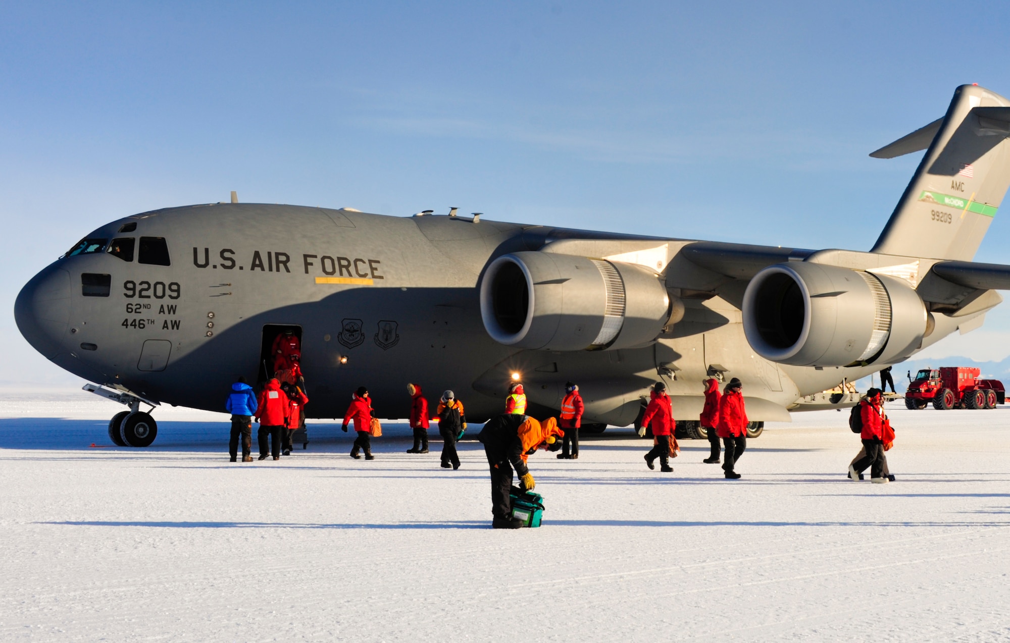 National Science Foundation personnel exit a C-17 Globemaster III aircraft, Oct. 1, 2012, at McMurdo Station, Antarctica. Every year, Airmen from the 62nd and 446th Airlift Wings at Joint Base Lewis-McChord deploy to transport cargo and personnel in support of the NSF and Operation Deep Freeze. (U.S. Air Force photo/Staff Sgt. Sean Tobin)