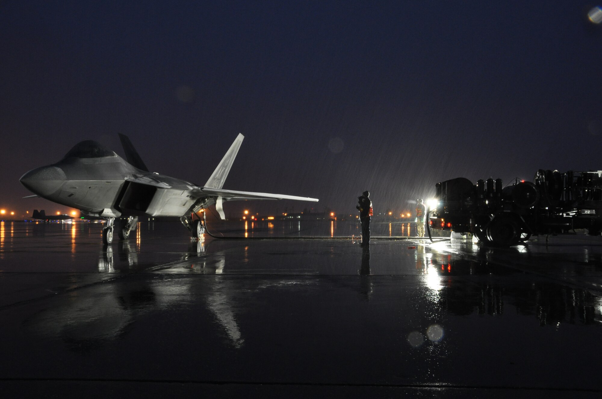 Airmen from the 3rd and 477th Aircraft Maintenance Squadrons perform a hot pit refuel with an F-22 here.  Hot pit refueling is a procedure performed in order to rapidly refuel the aircraft and allow it to complete a second sortie in a short amount of time. During a hot pit refuel the pilot will stay in the cockpit with the jet running while the maintenance crews perform safety checks and refuel the aircraft allowing it to return to flight in less than 30 minutes.    (U.S. Air Force Reserve/Tech. Sgt. Dana Rosso) 
