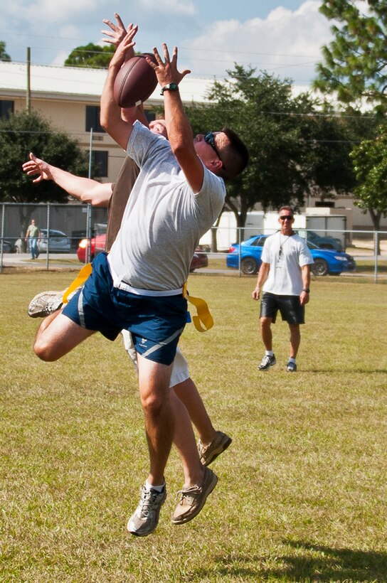 Senior Airman Christof Bader, of the 919th Aircraft Maintenance Squadron, goes up for a catch during a football game at Duke Field’s Family Day event Oct. 13.  The 919th Special Operations Wing sets aside a special day each year to show appreciation for its reservists and their family members.  Events include food, music, sports, children’s games, etc.  (U.S. Air Force photo/Tech. Sgt. Samuel King Jr.)