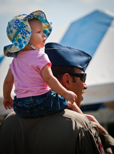A lieutenant colonel and his daughter check out the vendor booths at Duke Field’s Family Day event Oct. 13.  The 919th Special Operations Wing sets aside a special day each year to show appreciation for its reservists and their family members.  Events include food, music, sports, children’s games, etc.  (U.S. Air Force photo/Tech. Sgt. Samuel King Jr.)