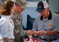 Staff Sgt. Alejandro Cano, of the 919th Maintenance Squadron, talks with Phil Considine, a Veterans of Foreign Wars member, at Duke Field’s Family Day event Oct. 13.  The 919th Special Operations Wing sets aside a special day each year to show appreciation for its reservists and their family members.  Events include food, music, sports, children’s games, etc.  (U.S. Air Force photo/Tech. Sgt. Samuel King Jr.)