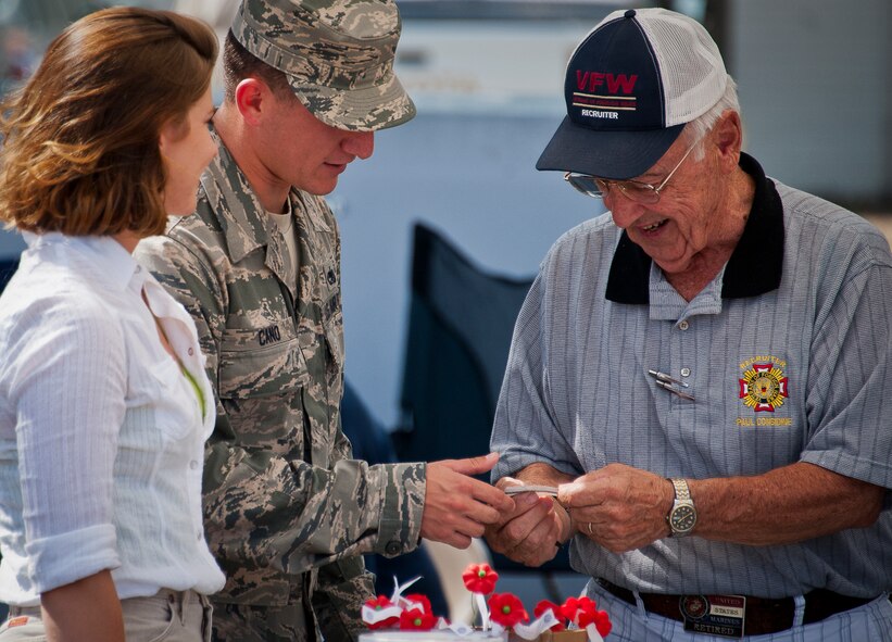 Staff Sgt. Alejandro Cano, of the 919th Maintenance Squadron, talks with Phil Considine, a Veterans of Foreign Wars member, at Duke Field’s Family Day event Oct. 13.  The 919th Special Operations Wing sets aside a special day each year to show appreciation for its reservists and their family members.  Events include food, music, sports, children’s games, etc.  (U.S. Air Force photo/Tech. Sgt. Samuel King Jr.)