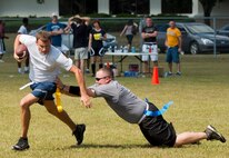 An Airman with the 919th Maintenance Squadron scrambles away from a defender during a flag football game at Duke Field’s Family Day event Oct. 13.  The 919th Special Operations Wing sets aside a special day each year to show appreciation for its reservists and their family members.  Events include food, music, sports, children’s games, etc.  (U.S. Air Force photo/Tech. Sgt. Samuel King Jr.)