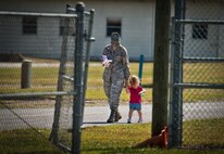 Airman 1st Class Abigail Ortiz, of the 919th Logistics Readiness Squadron, and her daughter walk back to Duke Field’s Family Day event Oct. 13.  The 919th Special Operations Wing sets aside a special day each year to show appreciation for its reservists and their family members.  Events include food, music, sports, children’s games, etc.  (U.S. Air Force photo/Tech. Sgt. Samuel King Jr.)