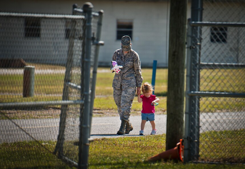Airman 1st Class Abigail Ortiz, of the 919th Logistics Readiness Squadron, and her daughter walk back to Duke Field’s Family Day event Oct. 13.  The 919th Special Operations Wing sets aside a special day each year to show appreciation for its reservists and their family members.  Events include food, music, sports, children’s games, etc.  (U.S. Air Force photo/Tech. Sgt. Samuel King Jr.)