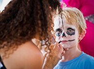 Khalin, the five-year-old son of Tech. Sgt. Sharelle Bateman, of the 919th Logistics Readiness Squadron, becomes a skeleton with the help of April Crooks at Duke Field’s Family Day event Oct. 13.  The 919th Special Operations Wing sets aside a special day each year to show appreciation for its reservists and their family members.  Events include food, music, sports, children’s games, etc.  (U.S. Air Force photo/Tech. Sgt. Samuel King Jr.)